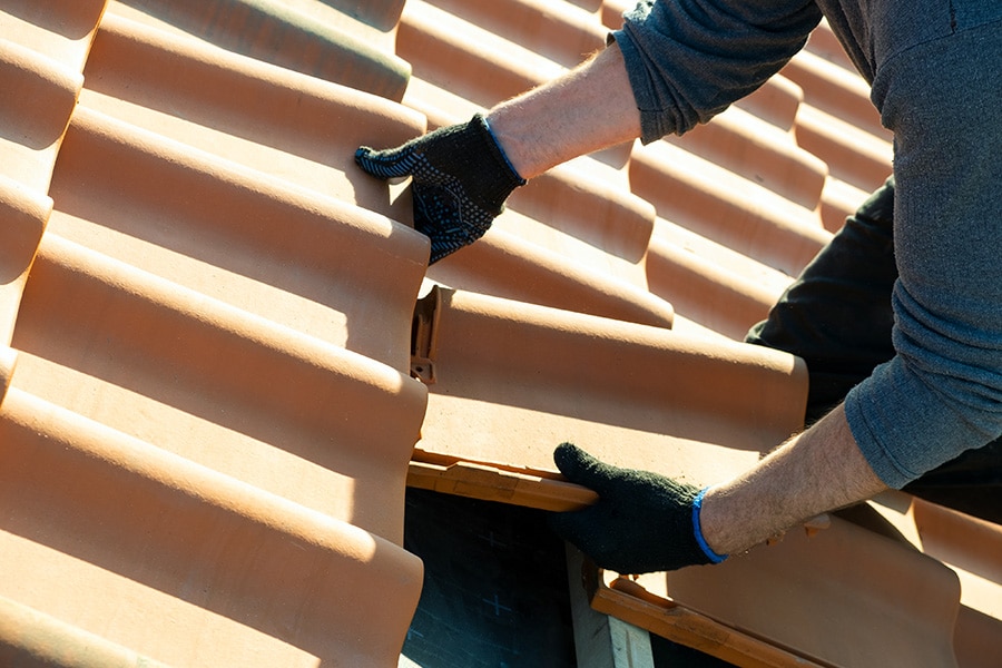 experienced roofer installing a tile roof