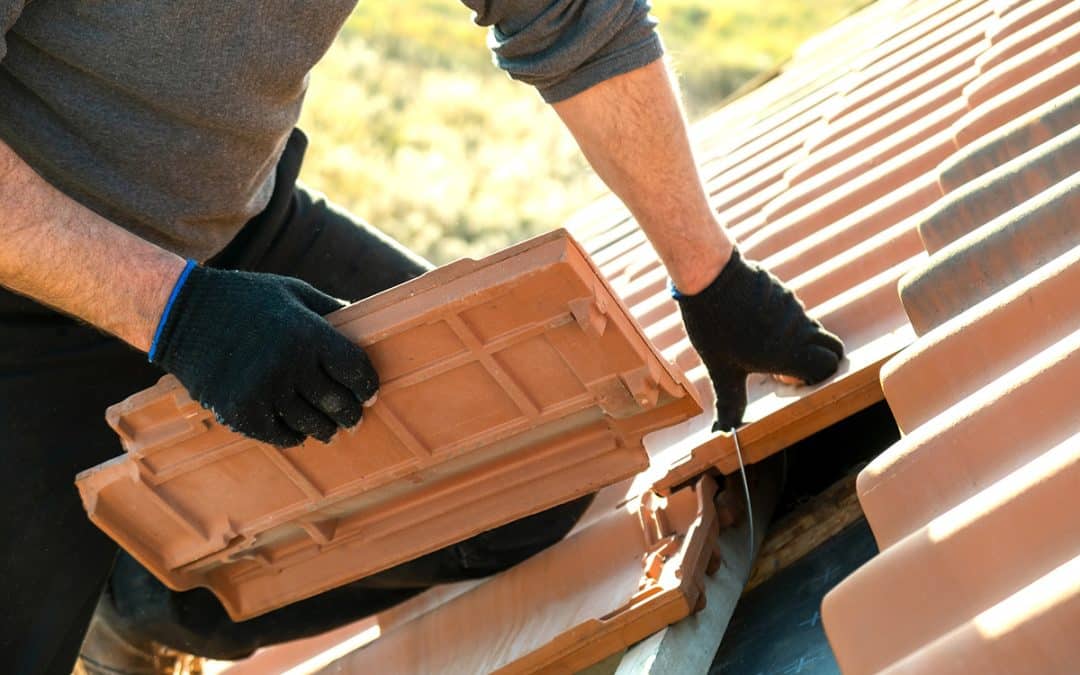 image showing professional roofer repairing slipped tile