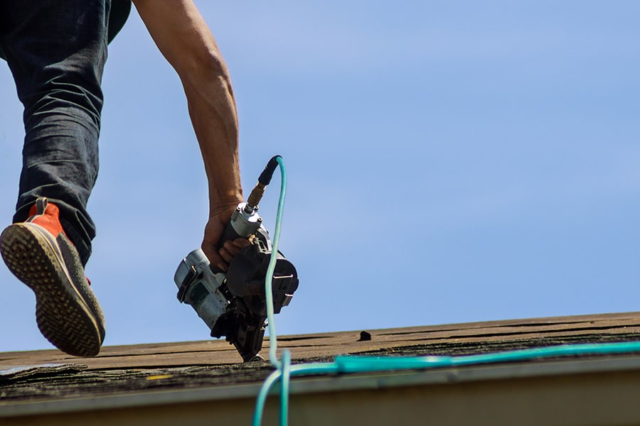 roofing contractor installing a new roof on a home