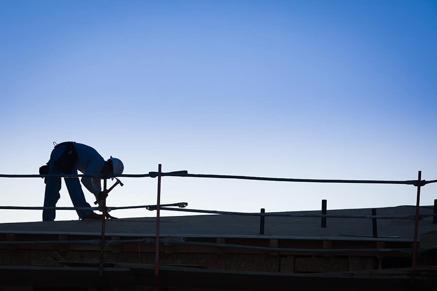 roofer completing a repair on a commercial roof